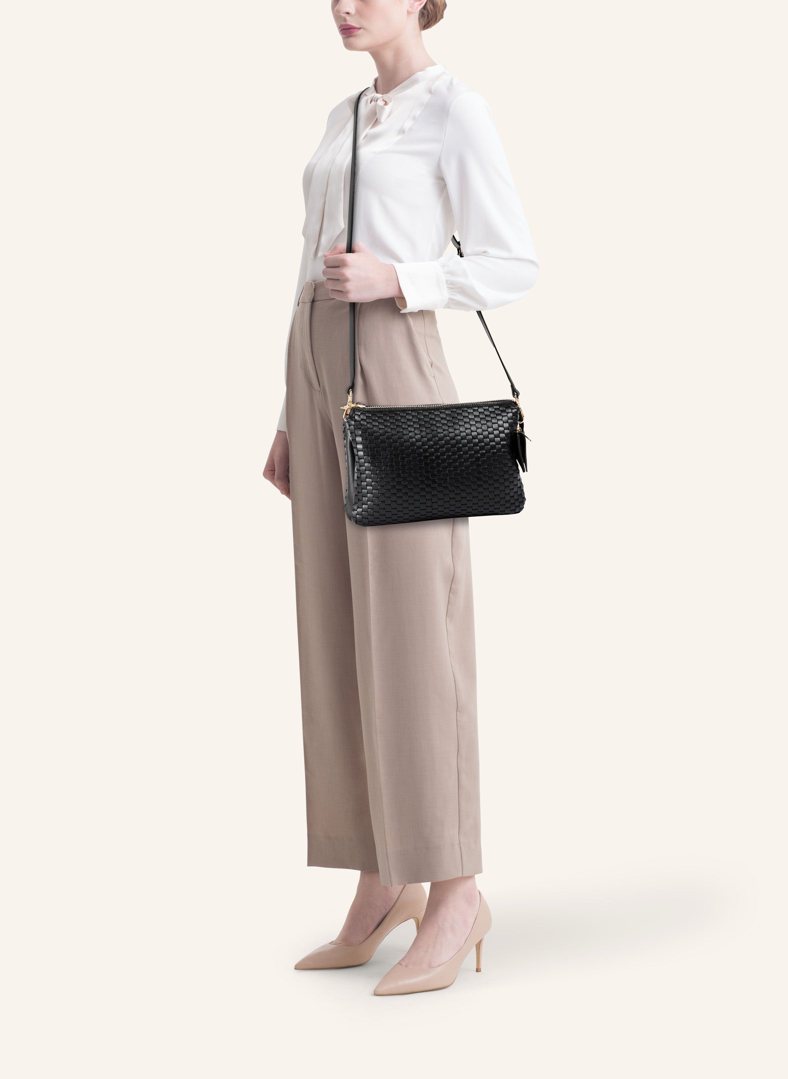 Model wearing the 21 Crossbody Bag, styled as a crossbody for a chic everyday look.