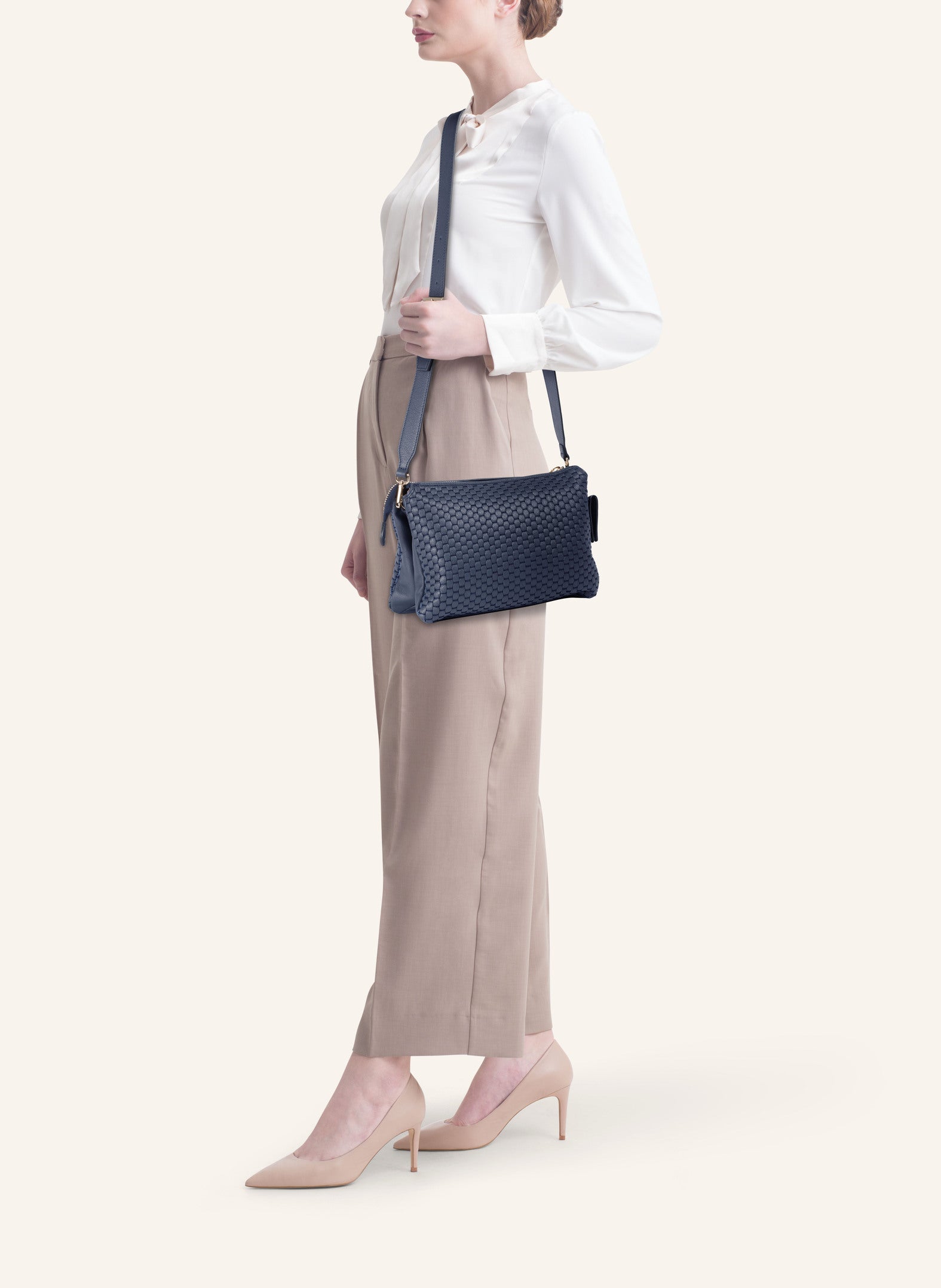 Model wearing the 21 Crossbody Bag, styled as a crossbody for a chic everyday look.