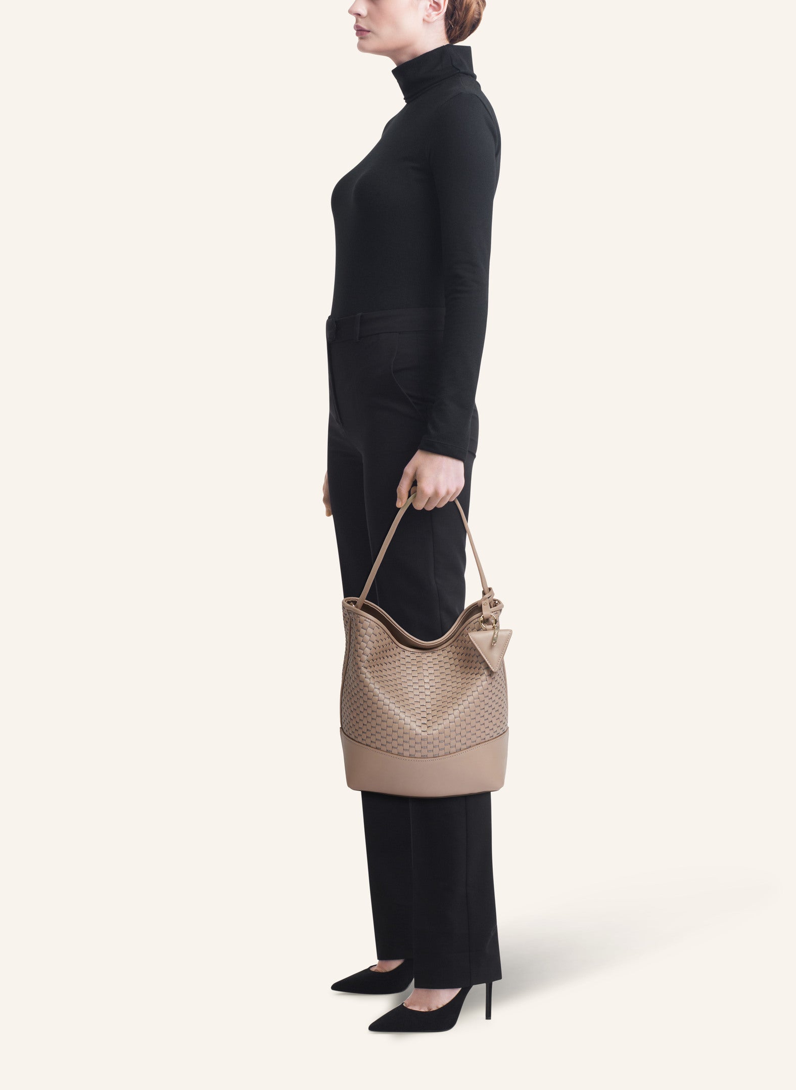 Model wearing the 51 Large Bucket Bag, styled as a sophisticated everyday statement piece.