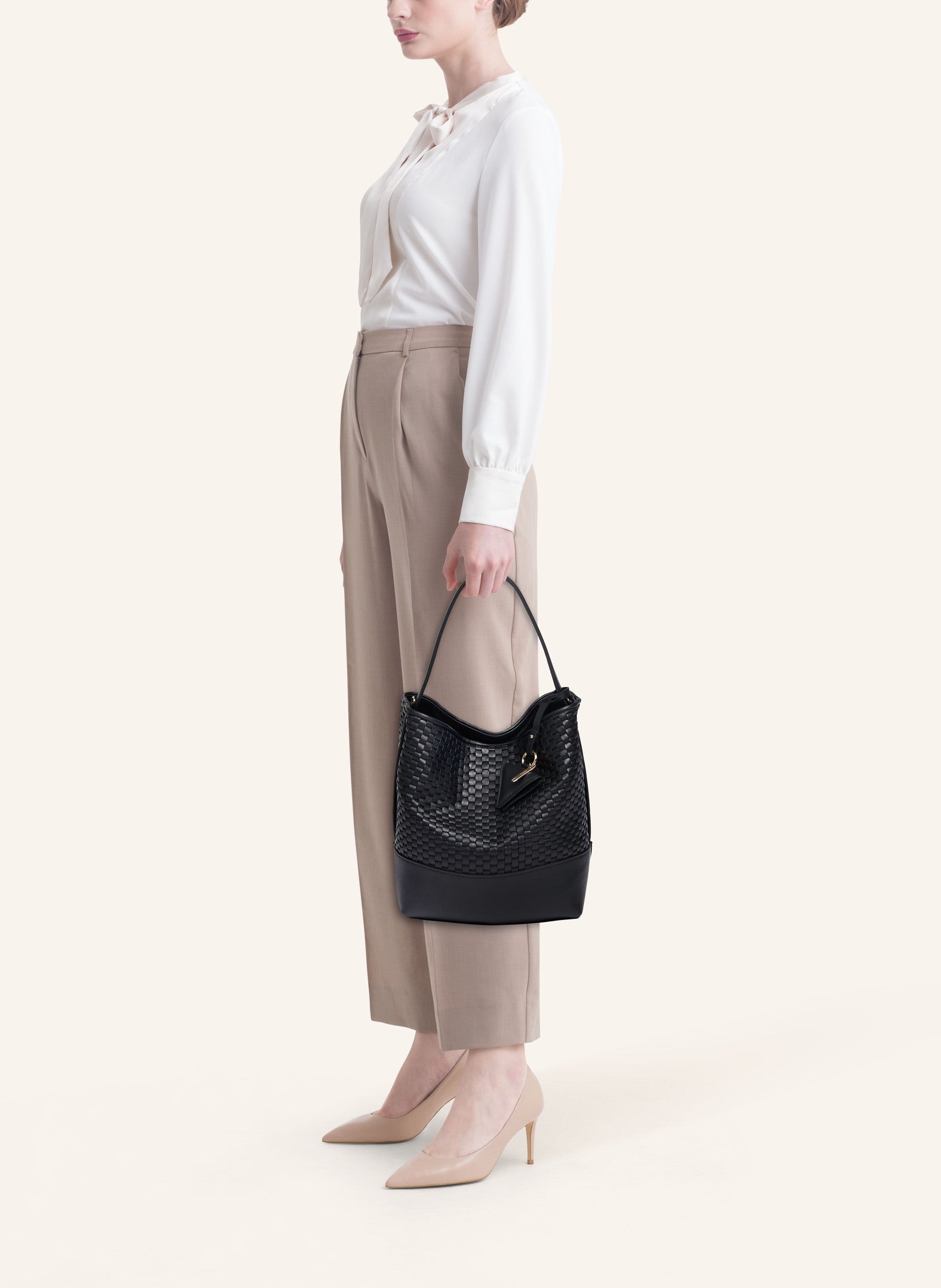 Model wearing the 51 Large Bucket Bag, styled as a sophisticated everyday statement piece.